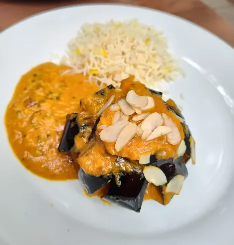 Aubergine dish with rice and sauce